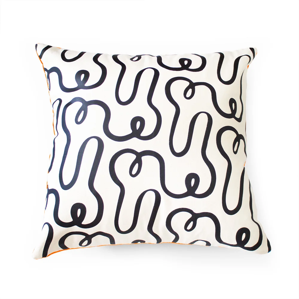 Cream-toned square with a soft black squiggle line, photographed against a clean white backdrop in calm minimalist style